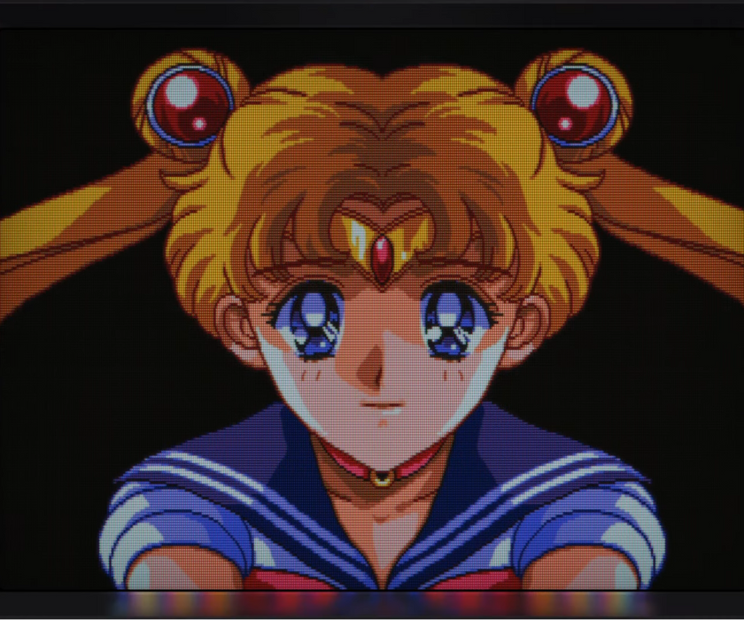 Animated character with blonde hair and blue eyes, wearing a sailor uniform, on a dark background.