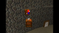 A retro 3D video game scene showing a small Mario-like character in a red hat and blue pants standing on a wooden crate against a dark stone wall, with another crate below and a door on the right.