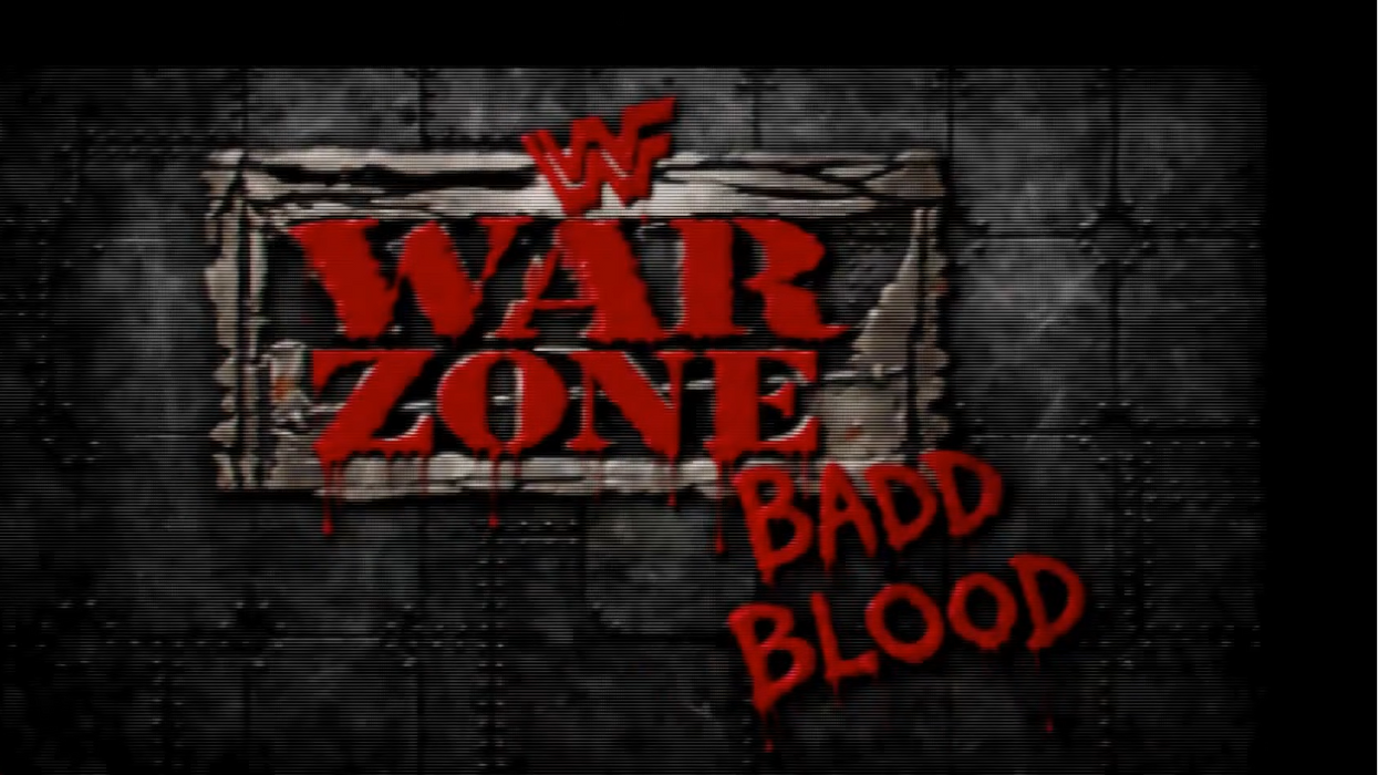 A dark graphic with the text 'War Zone' in large red letters on a torn banner, with 'Badd Blood' in red graffiti-style text below it. The background is a dark metallic industrial texture, and a small 'Wrestling World' logo appears in the lower-left corner.