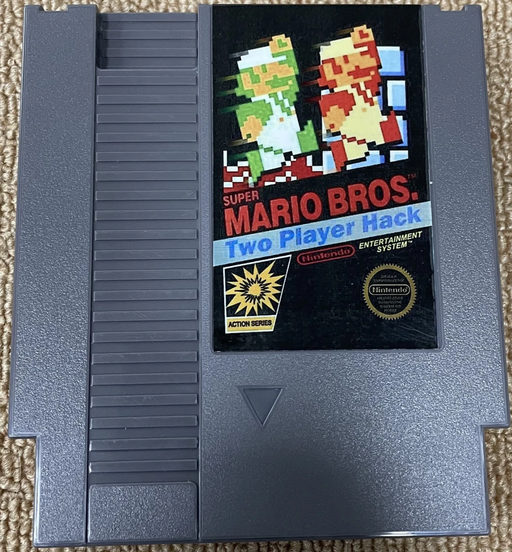 Super Mario Bros. Two Player Hack NES game cartridge on a beige carpet background